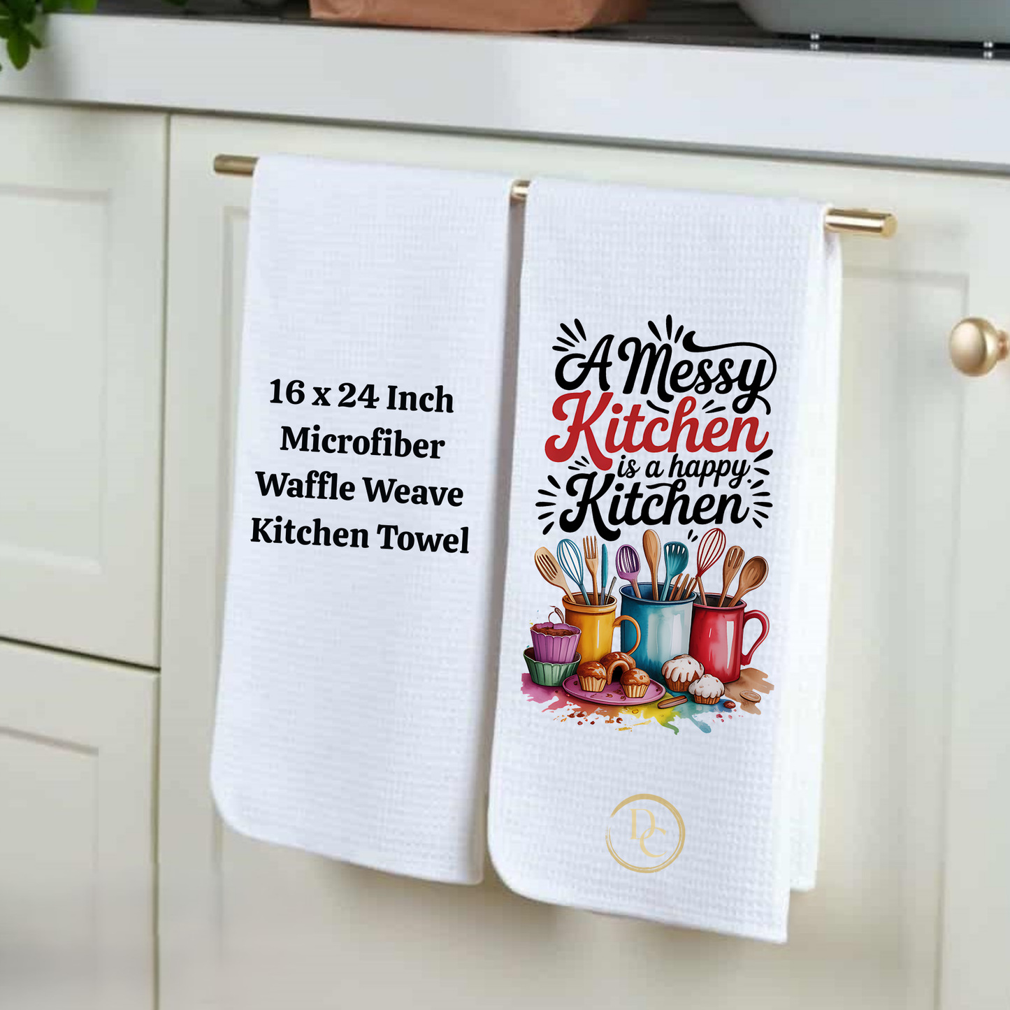 Two kitchen towels hanging on a cabinet handle, one with text and the other with a graphic design.