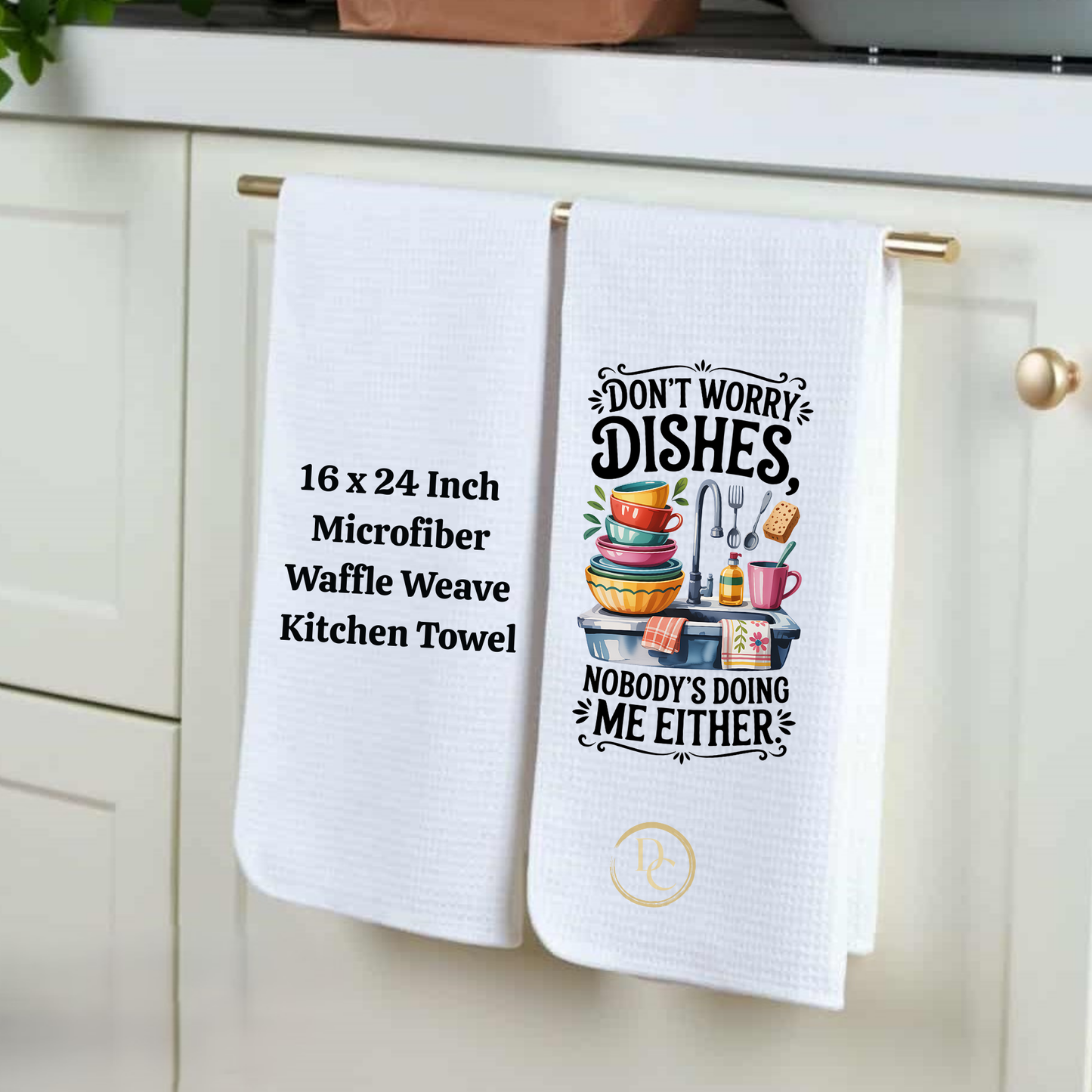 Two white kitchen towels hanging on a cabinet handle with humorous text design.