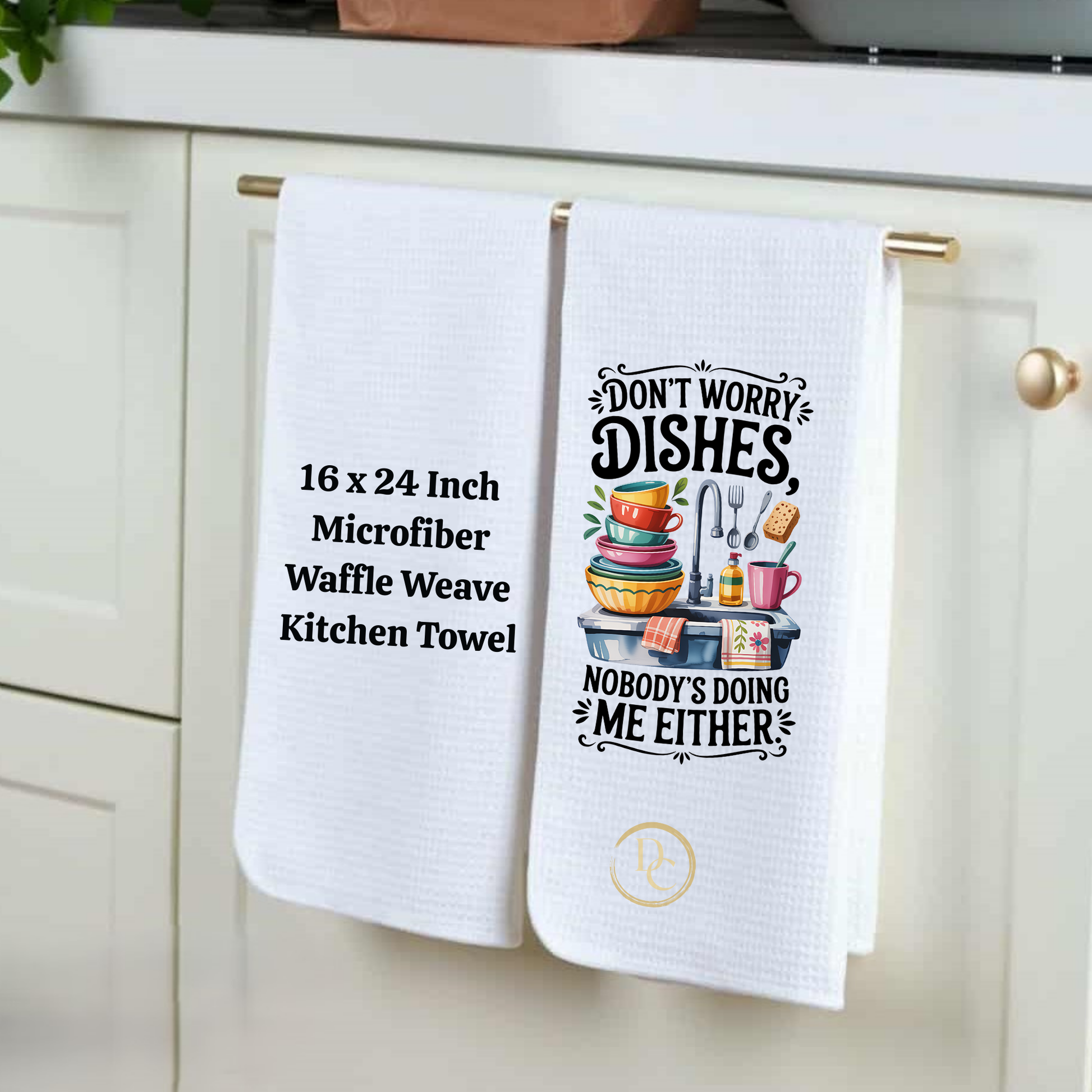 Two white kitchen towels hanging on a cabinet handle with humorous text design.