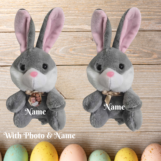  gray plush bunnies with pink ears on a wooden surface with colorful eggs.