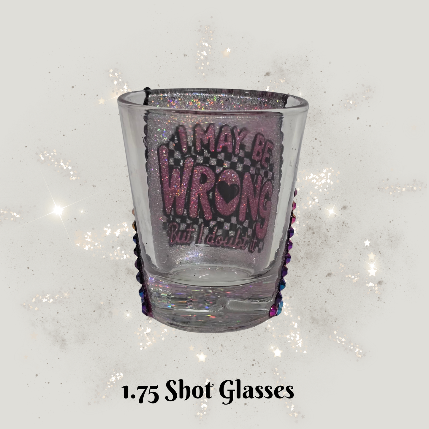 Clear shot glass with purple text on a glittery white background