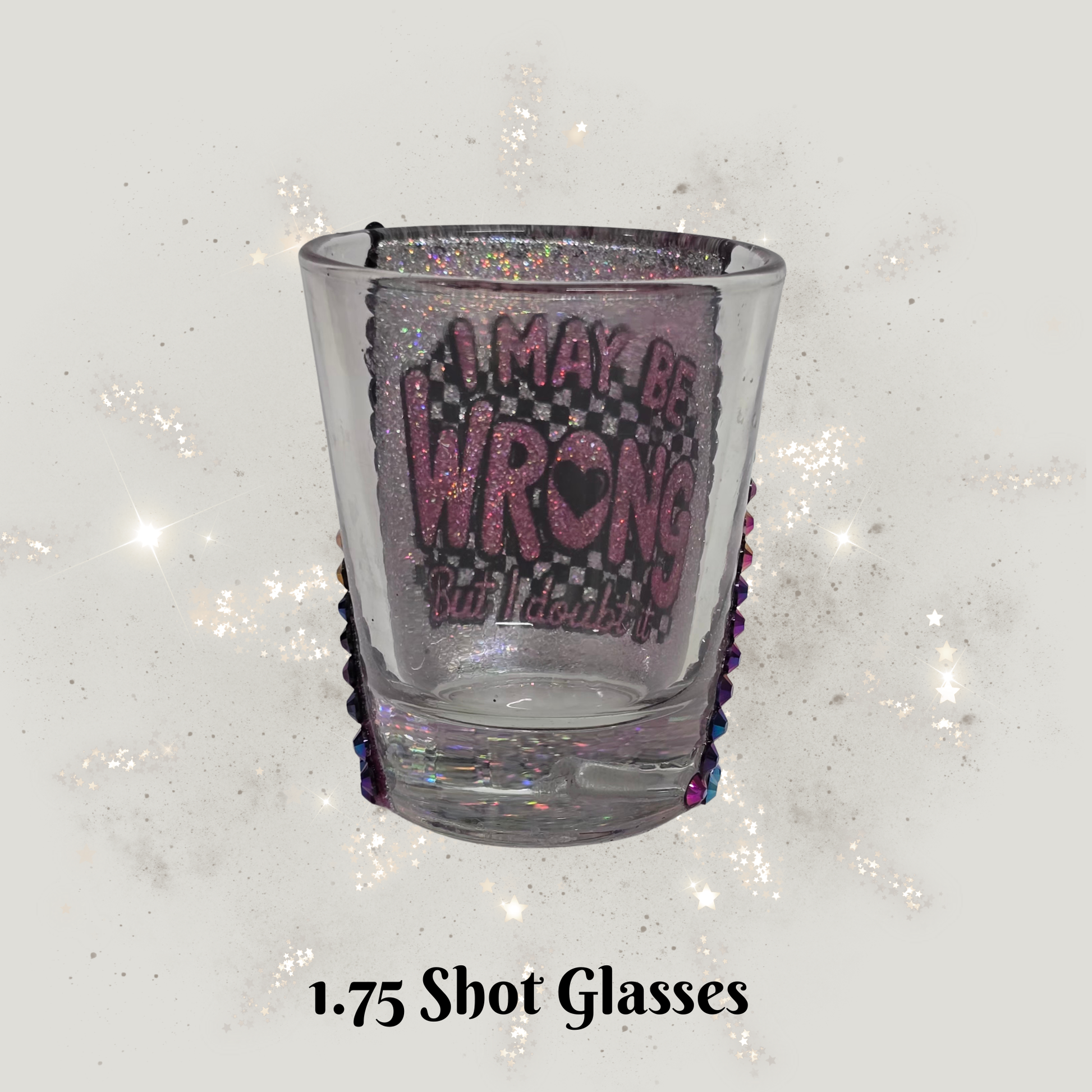 Clear shot glass with purple text on a glittery white background