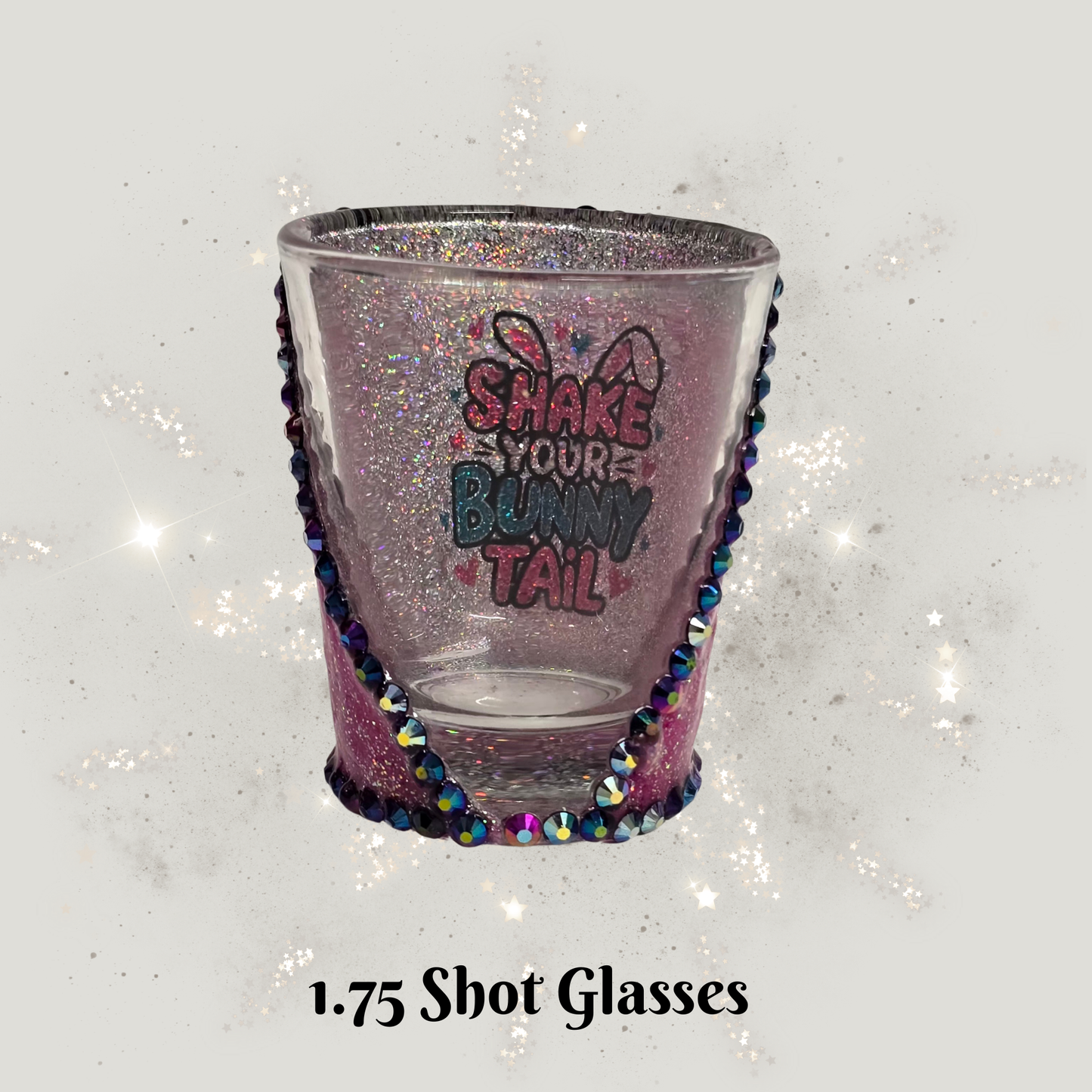 Decorative shot glass with colorful beading and text on a glittery background
