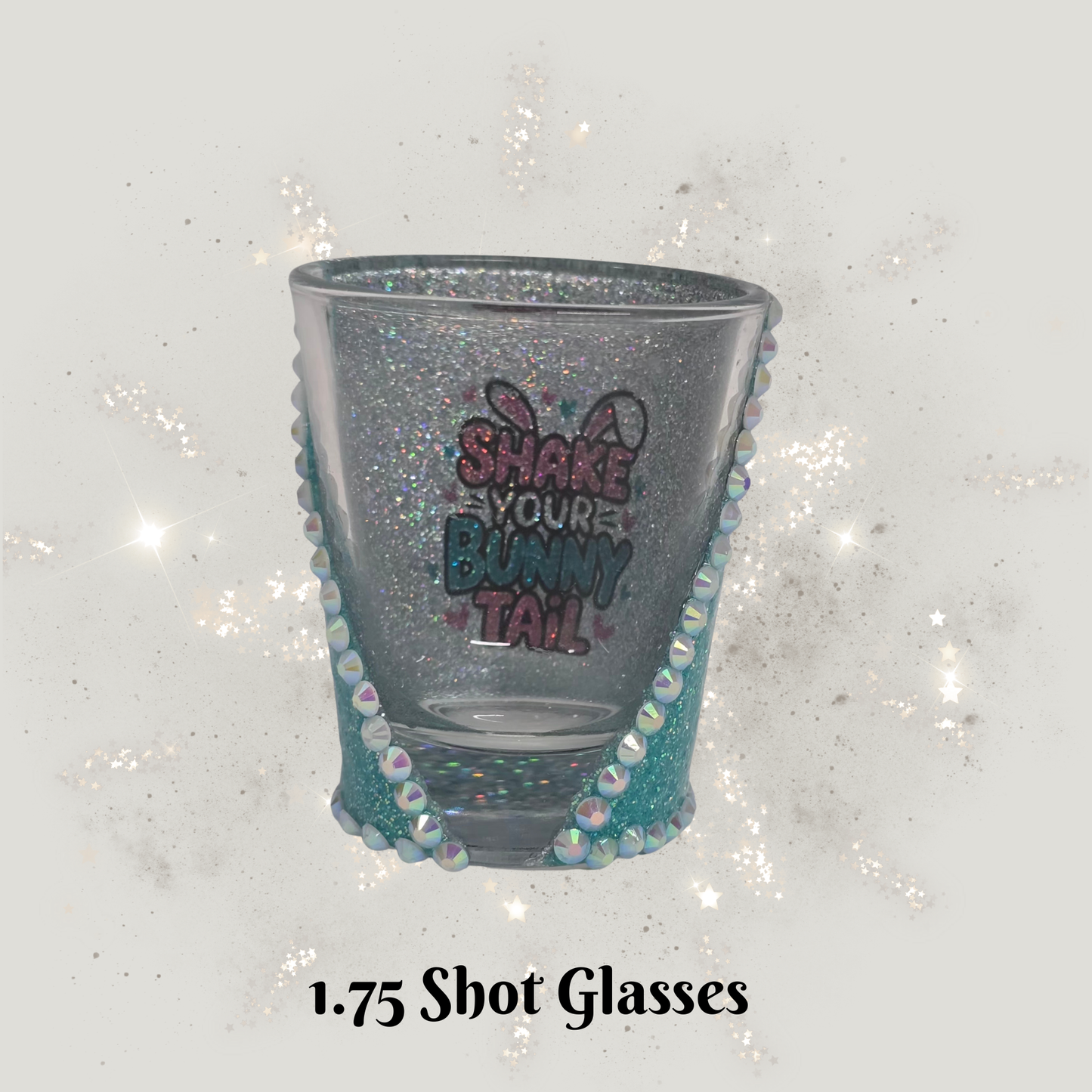 Decorative shot glass with glittery rim and text on a sparkling background