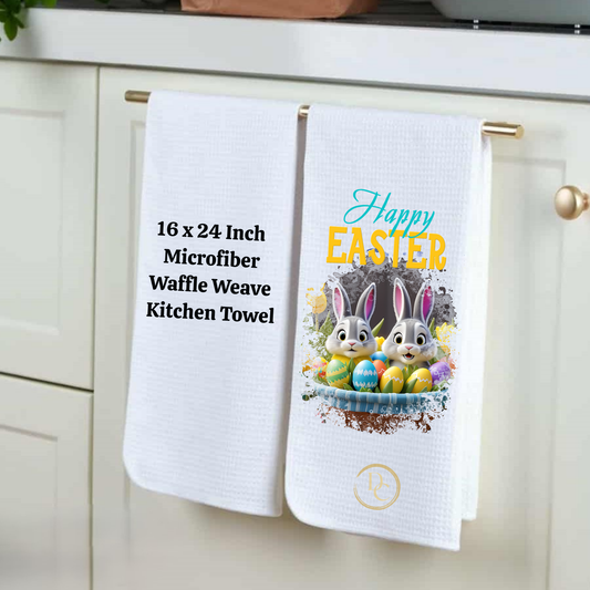 Two kitchen towels hanging on a cabinet handle, one with text and the other with an Easter design.